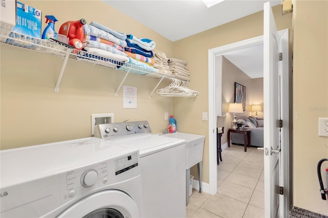 886 Suffolk Pl, Davenport, FL 33896 - washroom featuring washing machine and clothes dryer and light tile patterned flooring
