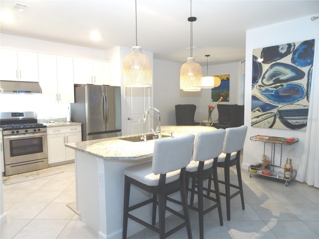 4957 Seafoam Trl, Bradenton, FL 34211 - kitchen with appliances with stainless steel finishes, under cabinet range hood, light stone countertops, and light tile patterned floors