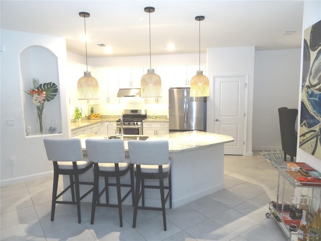 4957 Seafoam Trl, Bradenton, FL 34211 - kitchen featuring stainless steel appliances, under cabinet range hood, light tile patterned floors, and white cabinets