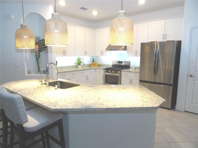 4957 Seafoam Trl, Bradenton, FL 34211 - kitchen with stainless steel appliances, wall chimney range hood, white cabinets, light tile patterned floors, and recessed lighting