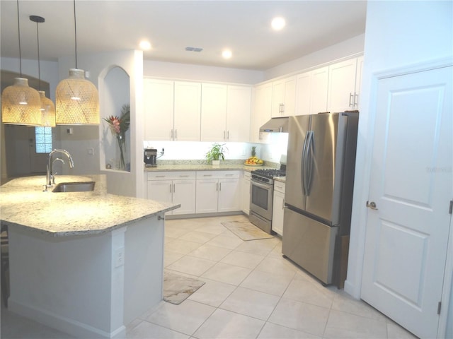 4957 Seafoam Trl, Bradenton, FL 34211 - kitchen featuring appliances with stainless steel finishes, light stone countertops, white cabinets, light tile patterned floors, and recessed lighting
