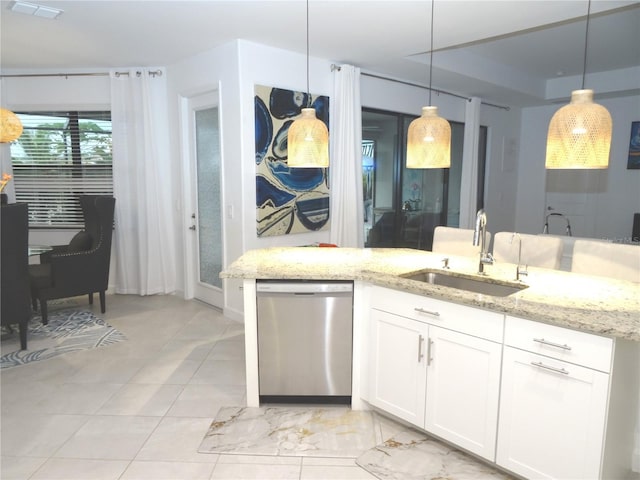 4957 Seafoam Trl, Bradenton, FL 34211 - kitchen with dishwasher, light stone countertops, white cabinetry, and hanging light fixtures