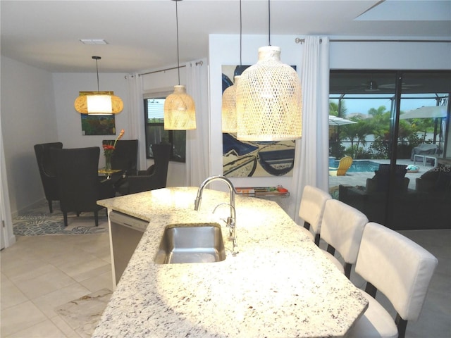 4957 Seafoam Trl, Bradenton, FL 34211 - kitchen featuring stainless steel dishwasher, light stone countertops, and pendant lighting
