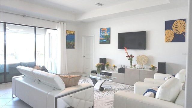 4957 Seafoam Trl, Bradenton, FL 34211 - living room with light tile patterned floors and a tray ceiling