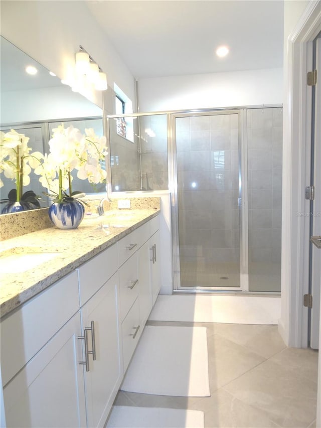 4957 Seafoam Trl, Bradenton, FL 34211 - bathroom featuring double vanity, a stall shower, tile patterned floors, and recessed lighting