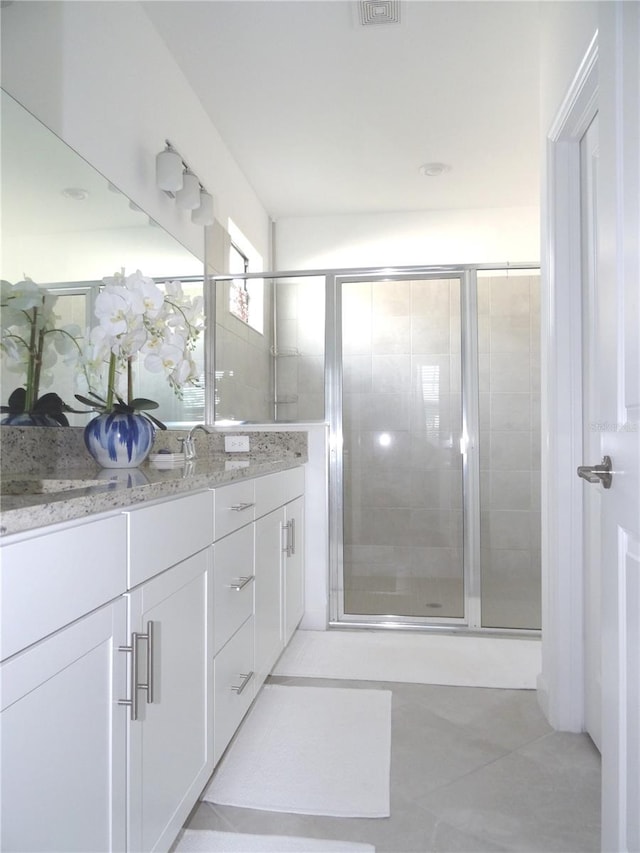 4957 Seafoam Trl, Bradenton, FL 34211 - full bathroom with double vanity, tile patterned floors, and a stall shower