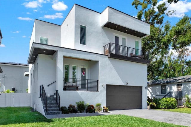 5006 W Idaho St, Tampa, FL 33616 - contemporary house featuring a balcony, an attached garage, and stucco siding