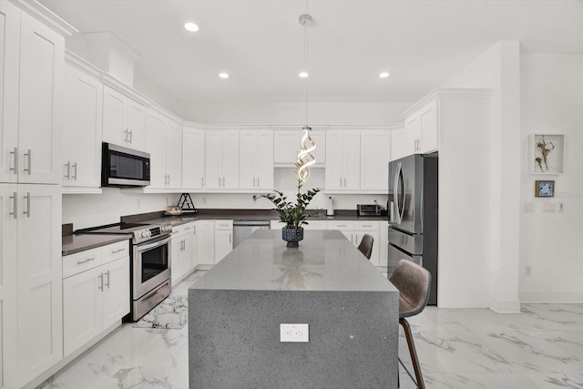 5006 W Idaho St, Tampa, FL 33616 - kitchen featuring appliances with stainless steel finishes, light marble finish floors, recessed lighting, a center island, and white cabinets