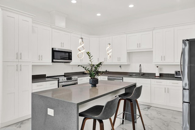 5006 W Idaho St, Tampa, FL 33616 - kitchen with stainless steel appliances, light marble finish flooring, recessed lighting, white cabinetry, and a kitchen bar