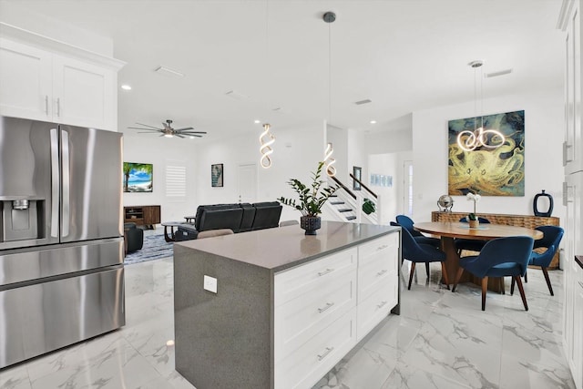 5006 W Idaho St, Tampa, FL 33616 - kitchen with stainless steel refrigerator with ice dispenser, light marble finish flooring, white cabinets, a kitchen island, and a ceiling fan