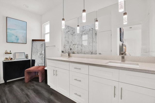 5006 W Idaho St, Tampa, FL 33616 - bathroom with double vanity, a marble finish shower, and wood finished floors