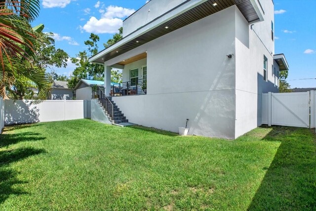 5006 W Idaho St, Tampa, FL 33616 - view of home's exterior with stairway, stucco siding, and a gate