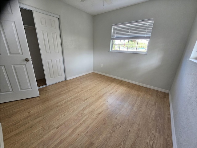 7001 60th St N, Pinellas Park, FL 33781 - unfurnished bedroom with wood finished floors and a closet