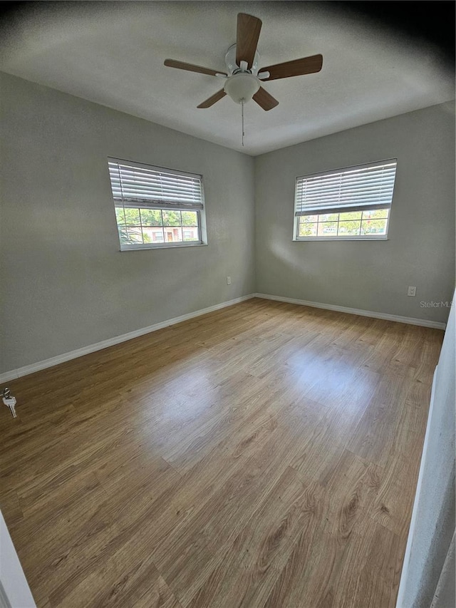 7001 60th St N, Pinellas Park, FL 33781 - unfurnished room featuring plenty of natural light, wood finished floors, and ceiling fan