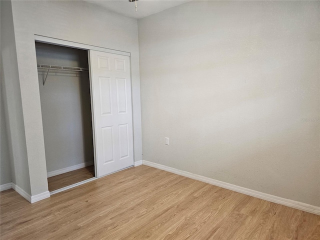 7001 60th St N, Pinellas Park, FL 33781 - unfurnished bedroom featuring light wood-type flooring and a closet