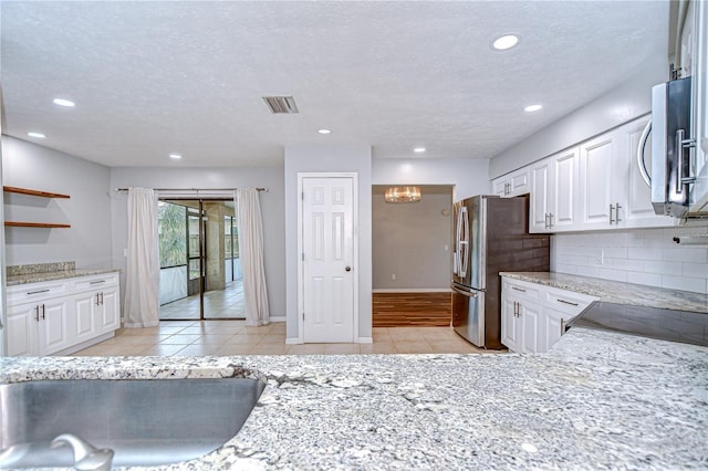 512 Pinewalk Dr, Brandon, FL 33510 - kitchen with light tile patterned floors, white cabinetry, a textured ceiling, and recessed lighting