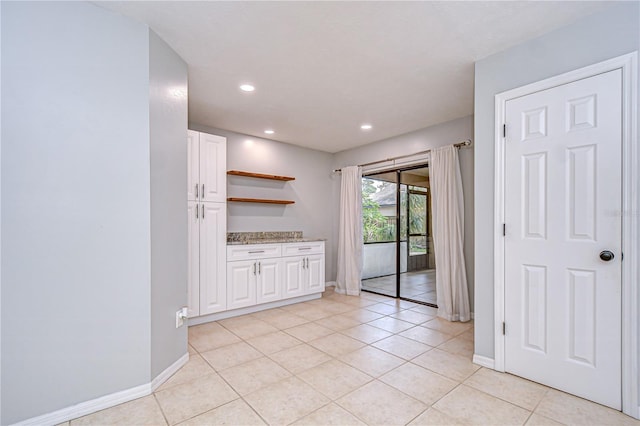 512 Pinewalk Dr, Brandon, FL 33510 - kitchen with white cabinets, open shelves, light tile patterned flooring, light stone counters, and recessed lighting