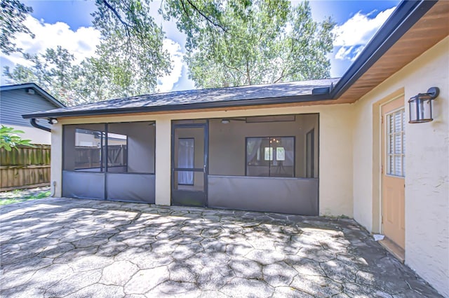 512 Pinewalk Dr, Brandon, FL 33510 - back of property featuring a sunroom, stucco siding, a patio area, and roof with shingles