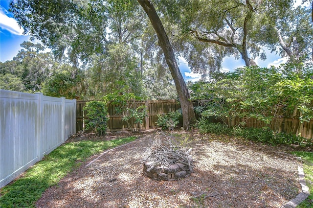 512 Pinewalk Dr, Brandon, FL 33510 - fenced backyard featuring an outdoor fire pit