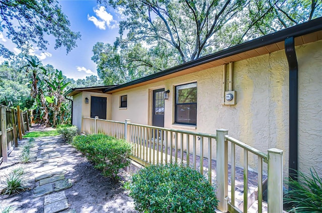 512 Pinewalk Dr, Brandon, FL 33510 - doorway to property featuring stucco siding and a wooden deck