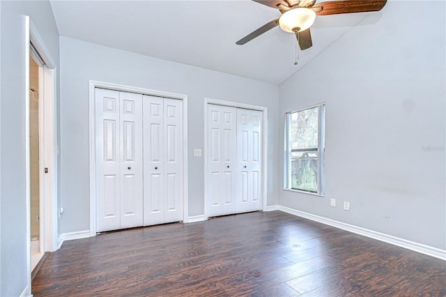 512 Pinewalk Dr, Brandon, FL 33510 - unfurnished bedroom featuring multiple closets, dark wood-style flooring, vaulted ceiling, and a ceiling fan