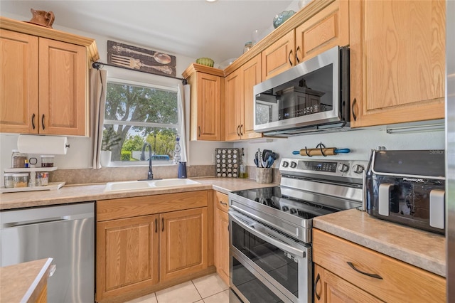 11830 Autumn Creek Dr, Riverview, FL 33569 - kitchen with appliances with stainless steel finishes, light countertops, and light tile patterned floors