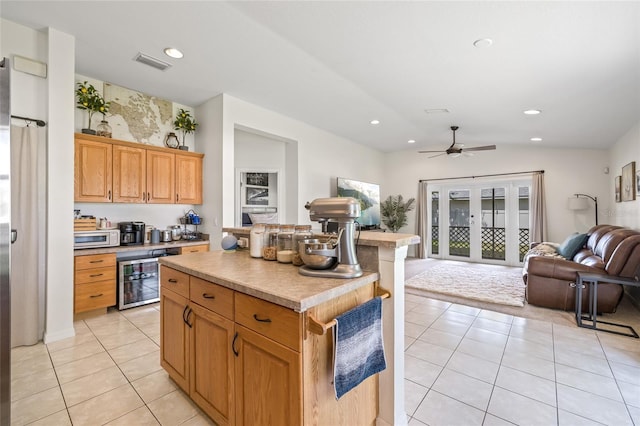 11830 Autumn Creek Dr, Riverview, FL 33569 - kitchen featuring beverage cooler, open floor plan, light tile patterned floors, a center island, and recessed lighting