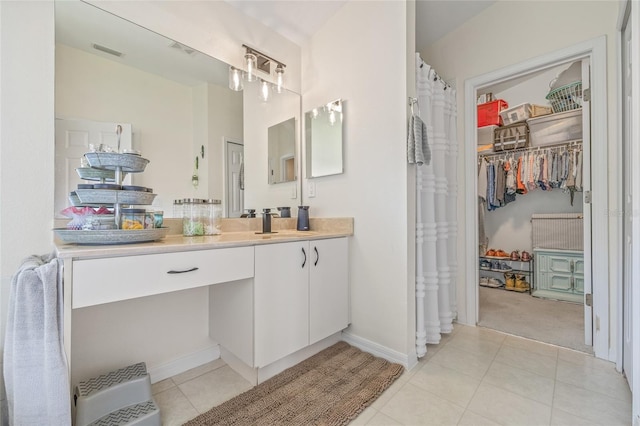11830 Autumn Creek Dr, Riverview, FL 33569 - bathroom with vanity, tile patterned flooring, and a walk in closet