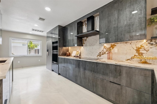 3197 Walnut St NE, Saint Petersburg, FL 33704 - kitchen with wall chimney exhaust hood, modern cabinets, black electric cooktop, backsplash, and double oven