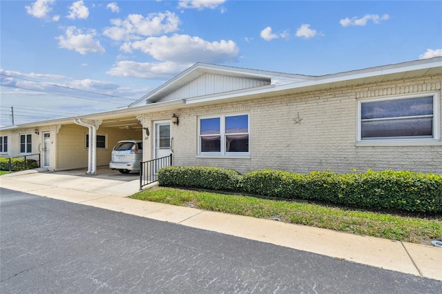 12400 Park Blvd Unit 519, Seminole, FL 33772 - view of front of property featuring a carport, brick siding, and concrete driveway