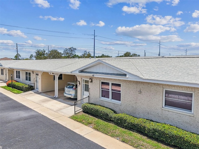 12400 Park Blvd Unit 519, Seminole, FL 33772 - ranch-style home with a shingled roof, a carport, brick siding, and concrete driveway