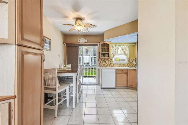 12400 Park Blvd Unit 519, Seminole, FL 33772 - kitchen with dishwasher, a ceiling fan, backsplash, light tile patterned floors, and glass insert cabinets