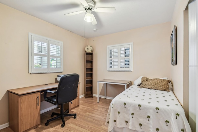 12400 Park Blvd Unit 519, Seminole, FL 33772 - bedroom with light wood-style flooring, a desk, and a ceiling fan