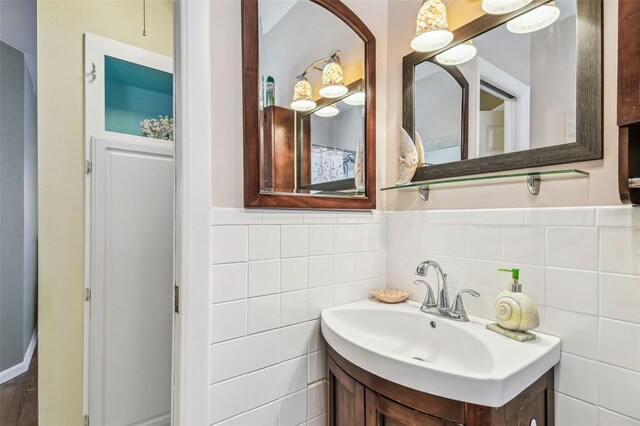 12400 Park Blvd Unit 519, Seminole, FL 33772 - bathroom featuring vanity, a wainscoted wall, and tile walls