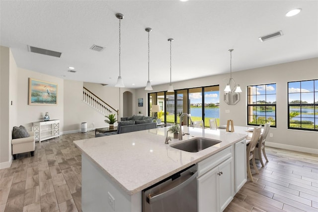 12821 Satin Lily Dr, Riverview, FL 33579 - kitchen featuring stainless steel dishwasher, open floor plan, a kitchen island with sink, hanging light fixtures, and recessed lighting
