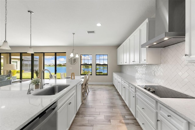 12821 Satin Lily Dr, Riverview, FL 33579 - kitchen with wall chimney exhaust hood, black electric stovetop, stainless steel dishwasher, recessed lighting, and tasteful backsplash