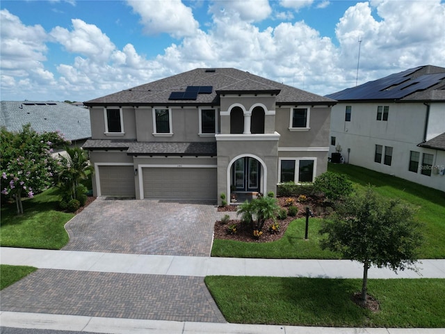 12821 Satin Lily Dr, Riverview, FL 33579 - mediterranean / spanish home featuring stucco siding, a garage, and a front yard