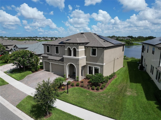 12821 Satin Lily Dr, Riverview, FL 33579 - view of front of property with stucco siding, a garage, driveway, roof with shingles, and a front lawn