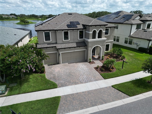 12821 Satin Lily Dr, Riverview, FL 33579 - view of front of property with stucco siding, decorative driveway, a garage, a water view, and a front lawn