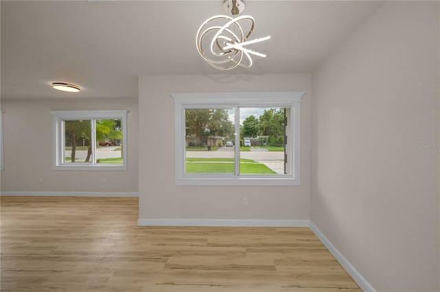 4441 16th St N, Saint Petersburg, FL 33703 - unfurnished dining area featuring a chandelier and light wood-style floors