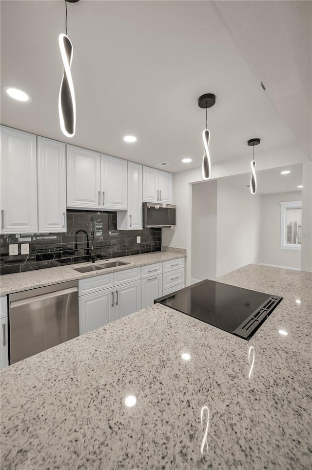 4441 16th St N, Saint Petersburg, FL 33703 - kitchen featuring stainless steel appliances, white cabinetry, light stone countertops, decorative backsplash, and pendant lighting