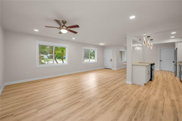 4441 16th St N, Saint Petersburg, FL 33703 - unfurnished living room with recessed lighting, light wood-style floors, ceiling fan, and a chandelier