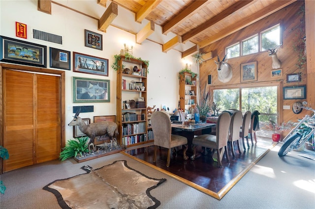 6924 Valrie Ln, Riverview, FL 33569 - carpeted dining space with wooden walls, a wood ceiling with exposed beams, and a high ceiling