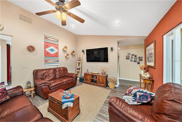 6709 Peachtree Dr, Temple Terrace, FL 33617 - living room featuring a ceiling fan, lofted ceiling, wood finished floors, recessed lighting, and a textured ceiling