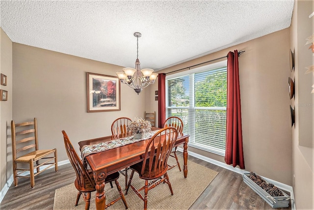 6709 Peachtree Dr, Temple Terrace, FL 33617 - dining room featuring a chandelier, wood finished floors, and a textured ceiling