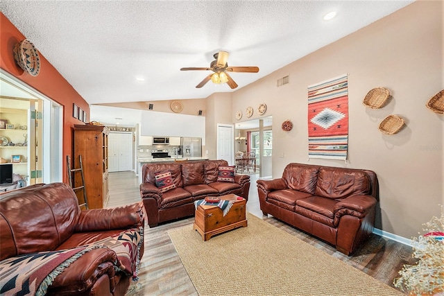 6709 Peachtree Dr, Temple Terrace, FL 33617 - living room with wood finished floors, a ceiling fan, lofted ceiling, a textured ceiling, and recessed lighting