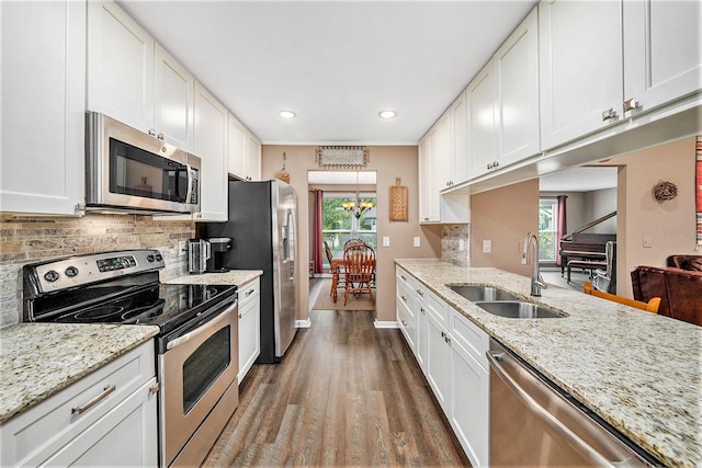 6709 Peachtree Dr, Temple Terrace, FL 33617 - kitchen featuring stainless steel appliances, a chandelier, dark wood-style flooring, decorative backsplash, and white cabinetry