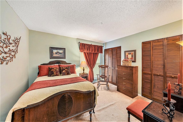 6709 Peachtree Dr, Temple Terrace, FL 33617 - bedroom featuring two closets, carpet floors, and a textured ceiling
