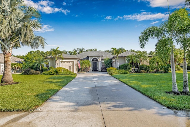 15420 27th Ct E, Parrish, FL 34219 - single story home featuring a garage, driveway, a front yard, and stucco siding