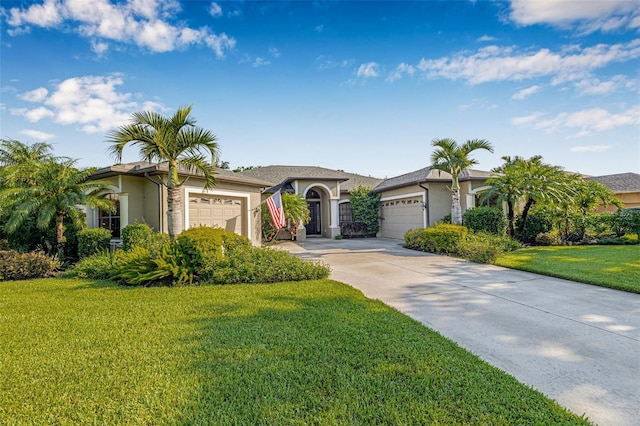 15420 27th Ct E, Parrish, FL 34219 - ranch-style home featuring an attached garage, stucco siding, a front lawn, and driveway